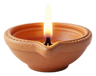 A clay diya oil lamp with a lit flame.